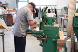 Nice CU of worker sanding in pattern shop Nice CU of worker sanding in pattern shop